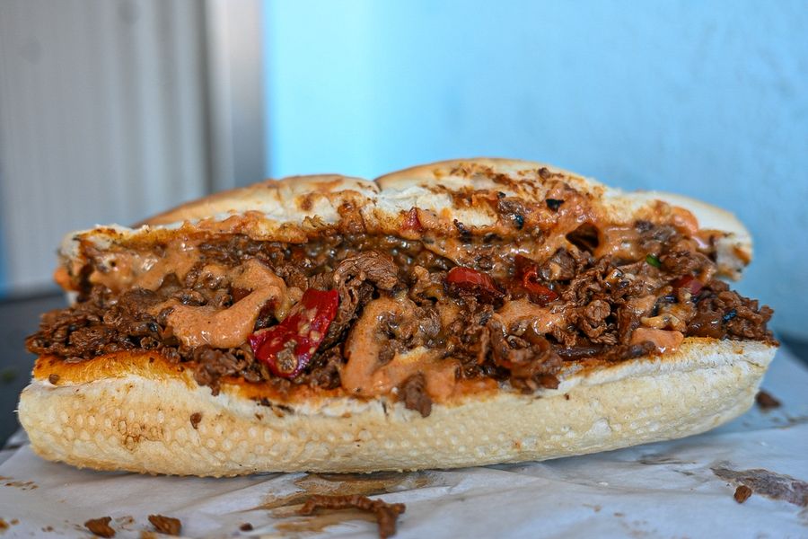 A loaded cheesesteak in a toasted roll